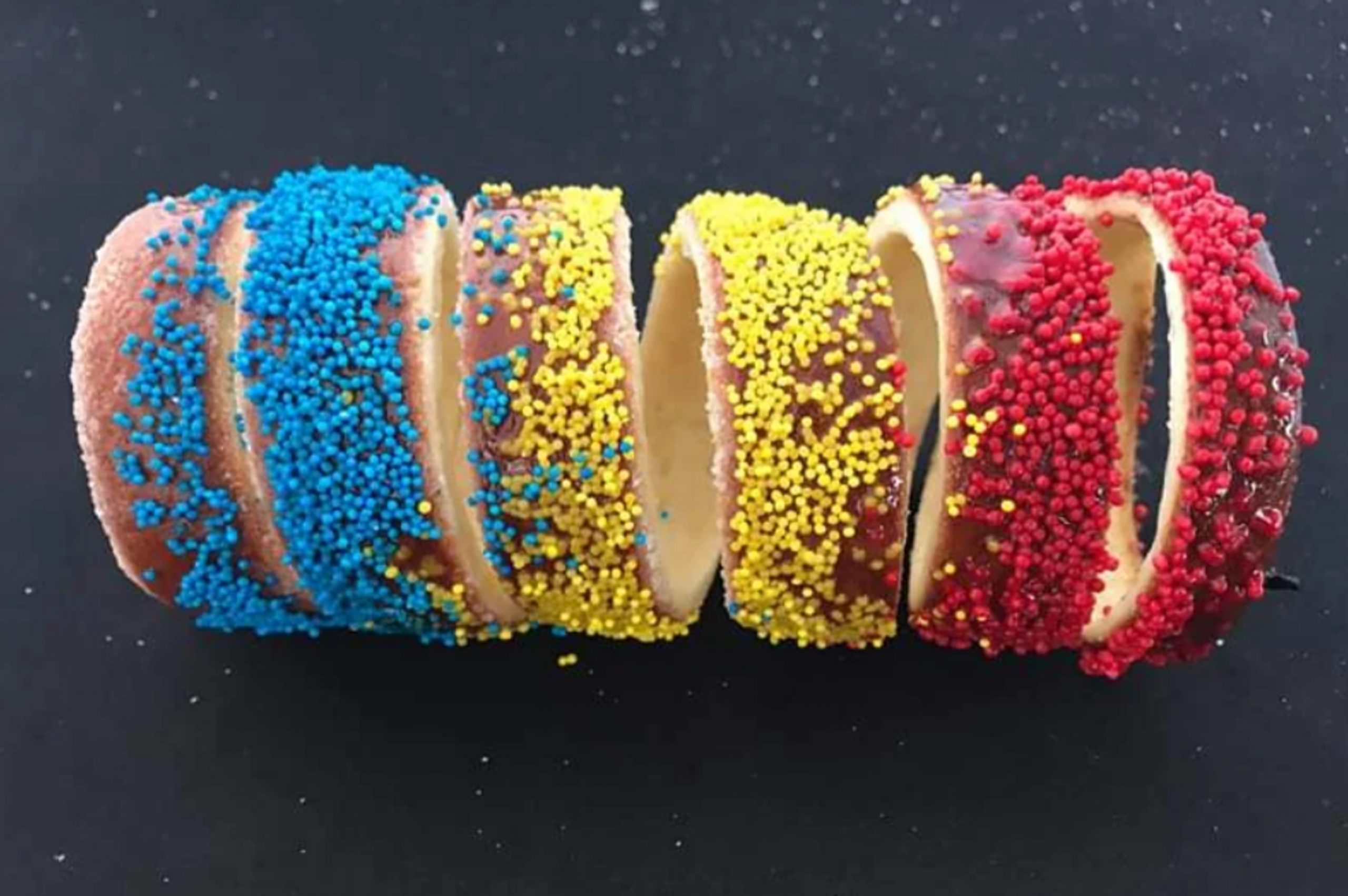 Produse tradiționale din Covasna: pâine de casă coaptă în cuptor de lemne și kürtőskalács rumenit, glazurat cu zahăr ars – delicii autentice recunoscute oficial pentru gustul lor unic.