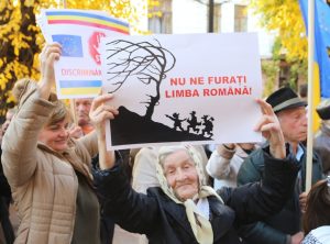 Români protestând pașnic pentru protejarea limbii române, ținând pancarte cu mesaje împotriva discriminării lingvistice.